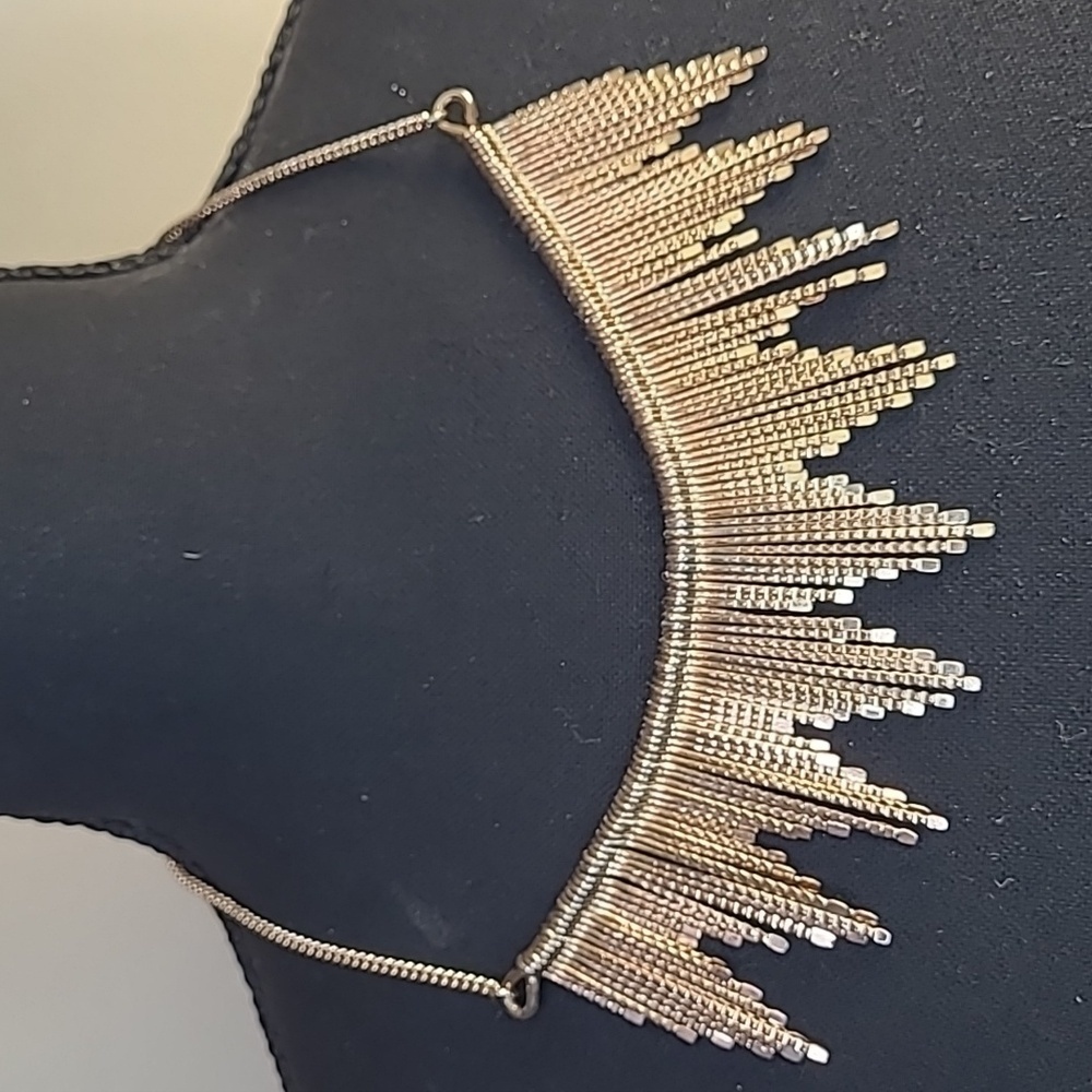 Gold tone dangly bib necklace. Full length 21"